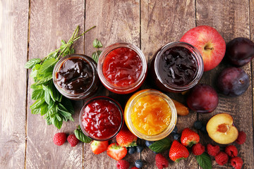 assortment of jams, seasonal berries, plums, mint and fruits
