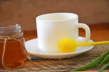 Hot drink with honey, lemon and aloe vera for cough remedy on wooden table