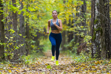 Woman running in the autumn park