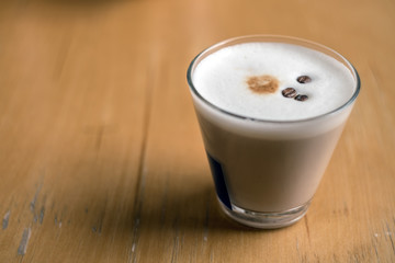 Cup of Hot Coffee served on wooden table