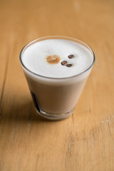 Cup of Hot Coffee served on wooden table
