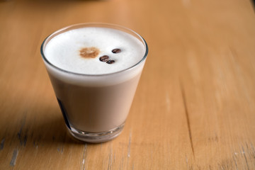 Cup of Hot Coffee served on wooden table