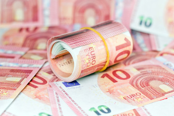 Ten euro rolled up on white background