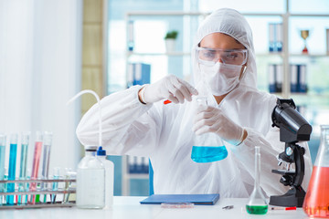 Chemist working in the laboratory with hazardous chemicals