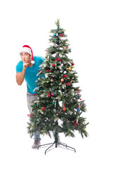Young man decorating christmas tree isolated on white