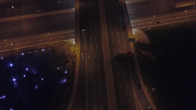 Aerial: Flyover of Moscow beltway with moving cars and evening cityscape