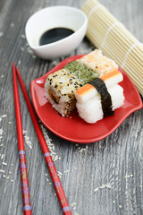 Sushi and soy sauce on the rustic table 