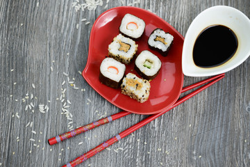 Sushi and soy sauce on the rustic table 