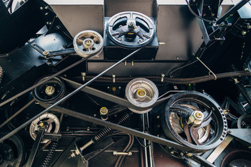 Mechanism of new modern agricultural combine harvester. Pulleys with drive belts. Industrial...
