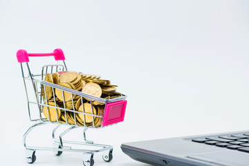 Shopping cart or supermarket trolley with laptop notebook on white background, e-commerce and online shopping concept.