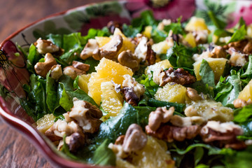 Pineapple Salad with greens on a wooden surface.