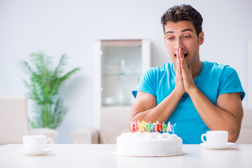 Young man celebrating birthday alone at home