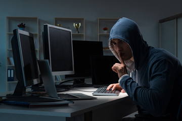 Hacker hacking computer at night