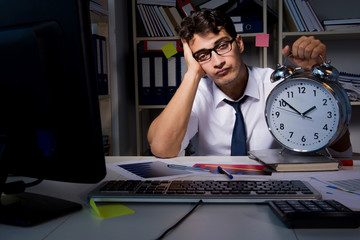 Man businessman working late hours in the office