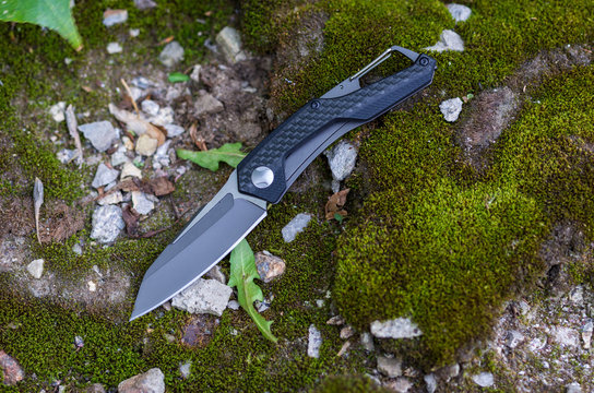 A pocket knife with a black handle and a black blade.