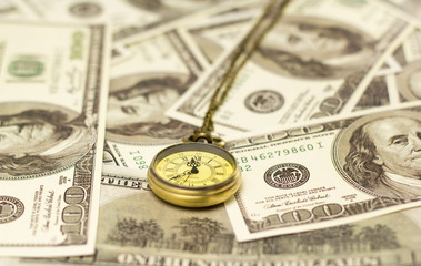 Time is money concept with pocket watch and dollars bills closeup