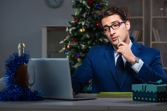 Businessman working late on christmas day in office