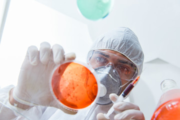 Fototapeta na wymiar Chemist working in the laboratory with hazardous chemicals 