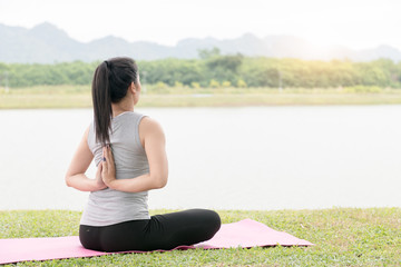 Fototapeta na wymiar young woman exercising and sitting in yoga position