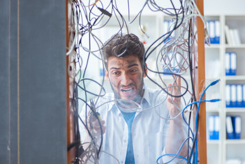 Computer repairman working on repairing network in IT workshop