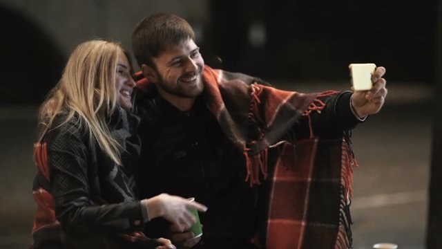 Young happy couple take selfie photos at camera on smart mobile cell phone 