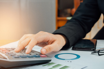 Close up hand of businesswoman accountant or banker using calculator, business finance calculation concept