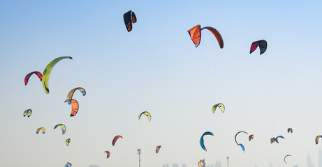 Kite surf kites flying over Jumeirah public beach in Dubai, UAE.
