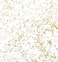 Scattered golden sparkles on white background. Festive backdrop.
