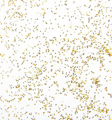 Scattered golden sparkles on white background. Festive backdrop.