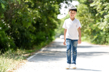 Fototapeta premium Boy walk on the road