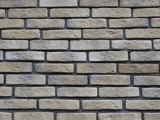 Brick wall with large gaps for cement. Unusual brick laying. Good background with an interesting smooth surface.