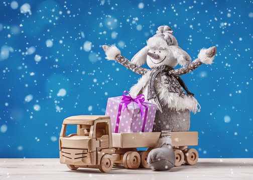 Toy truck with Christmas gifts and snowman.

