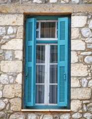 Greece, wooden green window of traditional stone house