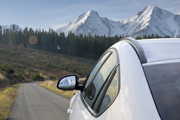 Naklejka premium White, modern SUV on the mountain road