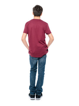 Rear view, teen boy standing at studio