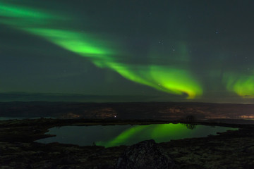 Aurora in the sky and the reflection in the water.