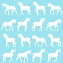 Unicorn silhouettes over blue background