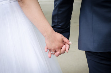 bride and groom holding hands at the wedding