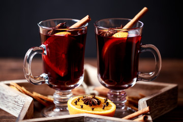 Christmas hot mulled wine in a glass with spices and citrus fruit. Mulled wine with cinnamon, anise and orange