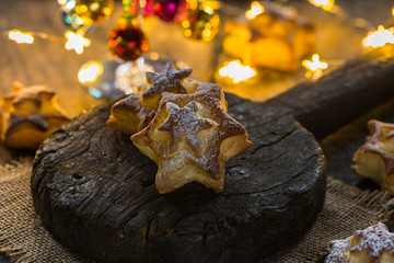 Star shaped cookies on wooden board. Christmas baking.
