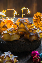 Star shaped cookies on wooden board. Christmas baking.