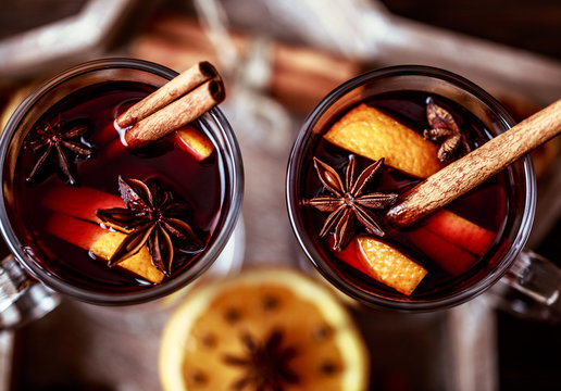 Christmas hot mulled wine in a glass with spices and citrus fruit. Mulled wine with cinnamon, anise and orange