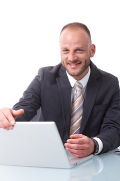 Happy businessman shutting down laptop