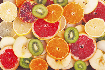 Fruit textures. Kiwi orange grapefruit lemon apple pear pomegranate mandarin fruits as background cover wallpaper. Colorful fresh fruits in rainbow colors. Beautiful delicious fruits wallpaper. Sweet.