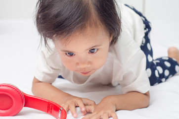 Asian little girl playing on the bed at home.