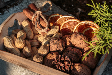 Little Wooden Box with Walnuts, Groundnut Seeds, Cinnamon Sticks and Dehydrated Orange Slices