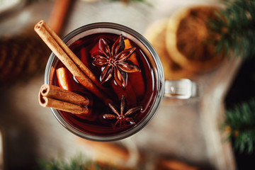 Christmas hot mulled wine in a glass with spices and citrus fruit. Mulled wine with cinnamon, anise...