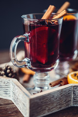 Christmas hot mulled wine in a glass with spices and citrus fruit. Mulled wine with cinnamon, anise and orange