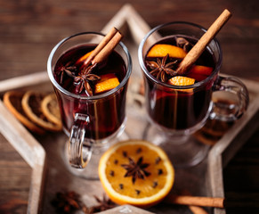Christmas hot mulled wine in a glass with spices and citrus fruit. Mulled wine with cinnamon, anise...