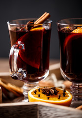 Christmas hot mulled wine in a glass with spices and citrus fruit. Mulled wine with cinnamon, anise and orange